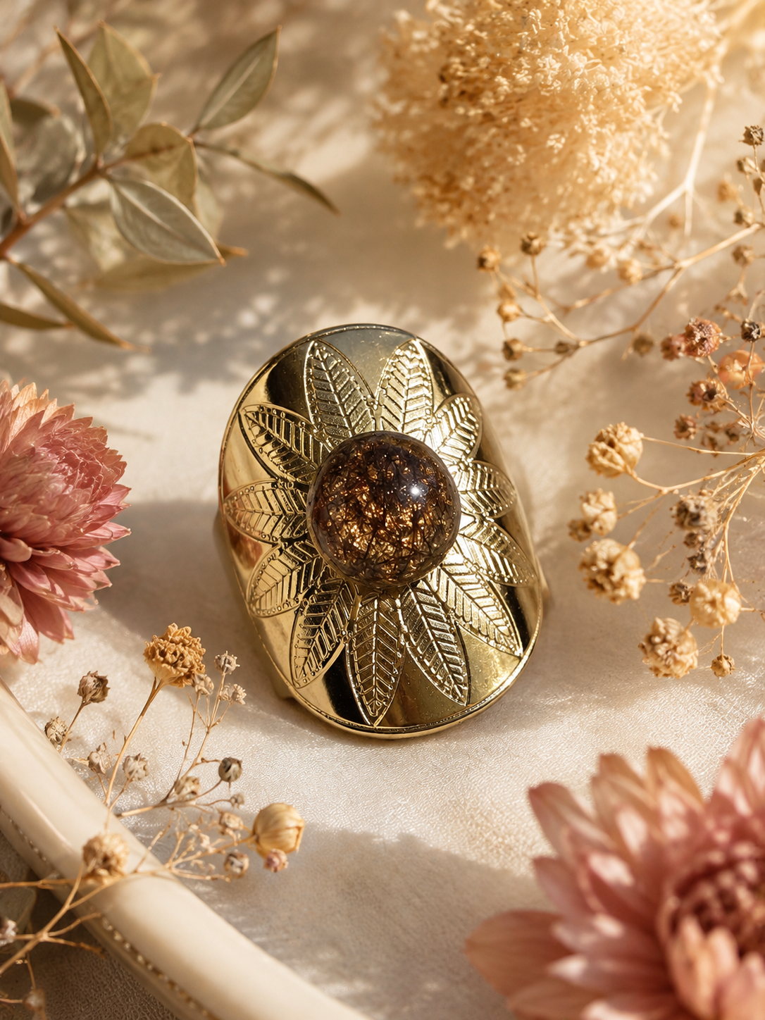 Bague chevalière dorée avec cabochon ambre doré scintillant et motif feuilles